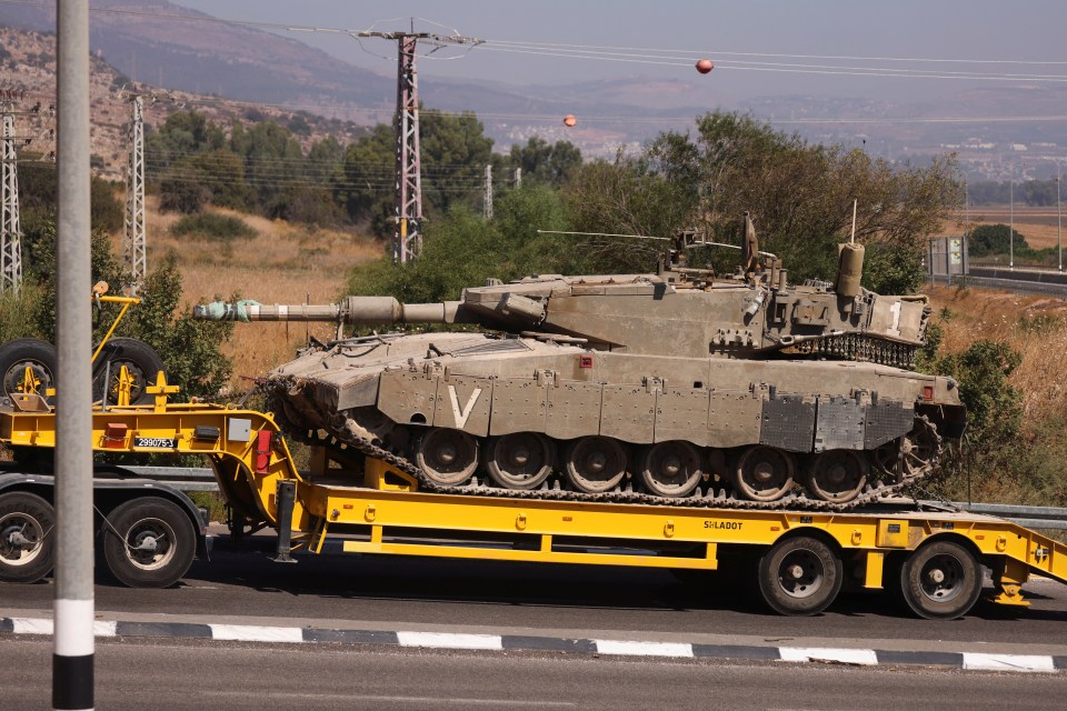 Israeli Army tanks are transported, amid cross-border hostilities between Hezbollah and Israel, in northern Israel, on Thursday