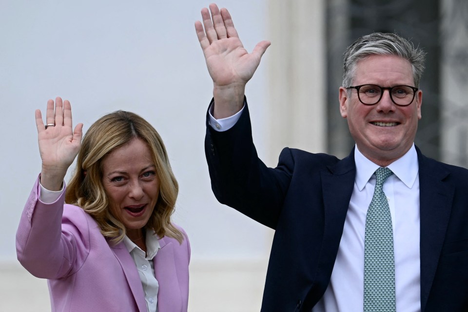 a man and a woman are waving their hands in the air