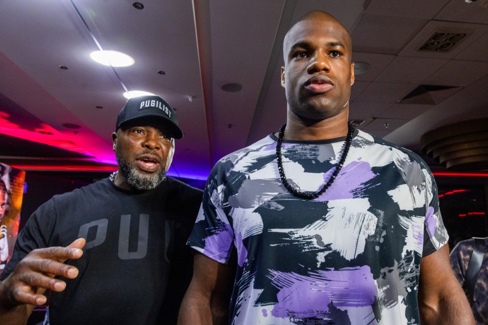 two men standing next to each other one wearing a black hat that says publicity