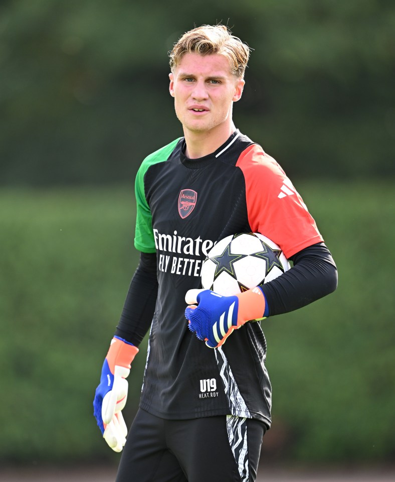 a soccer player wearing a jersey that says emirates fly better