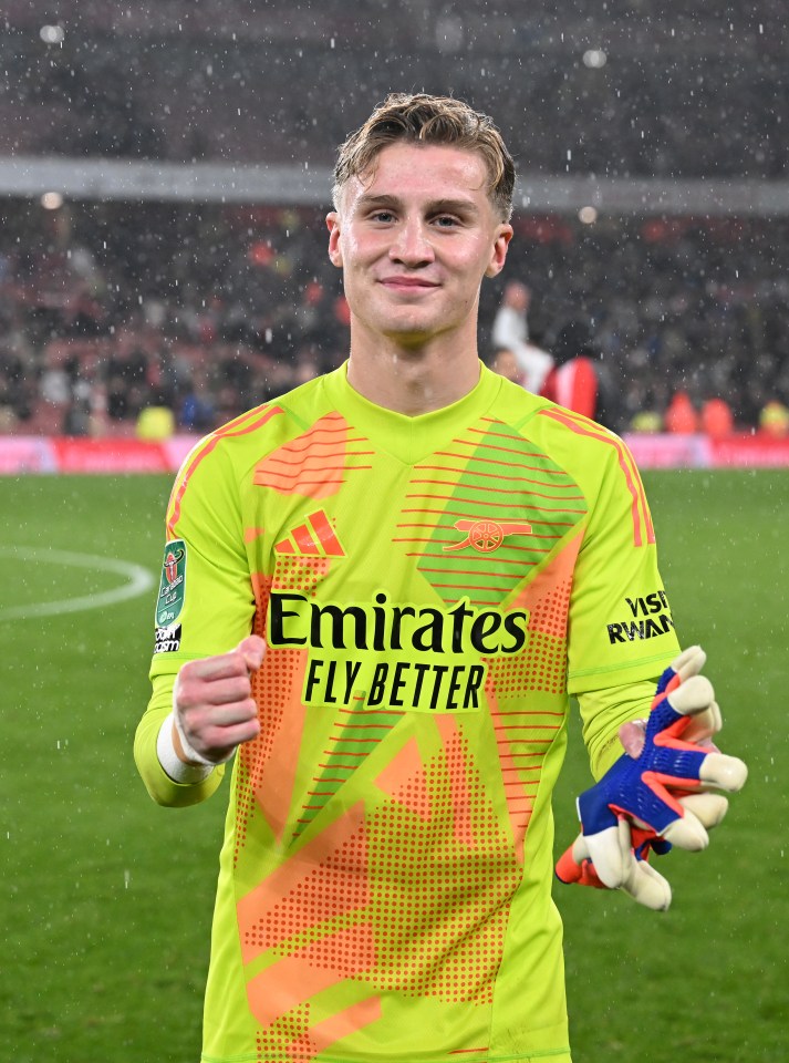 a soccer player wearing a jersey that says emirates fly better