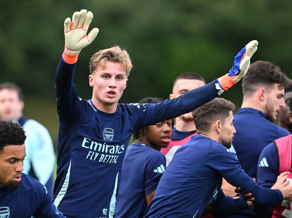 a soccer player wearing a shirt that says emirates fly better