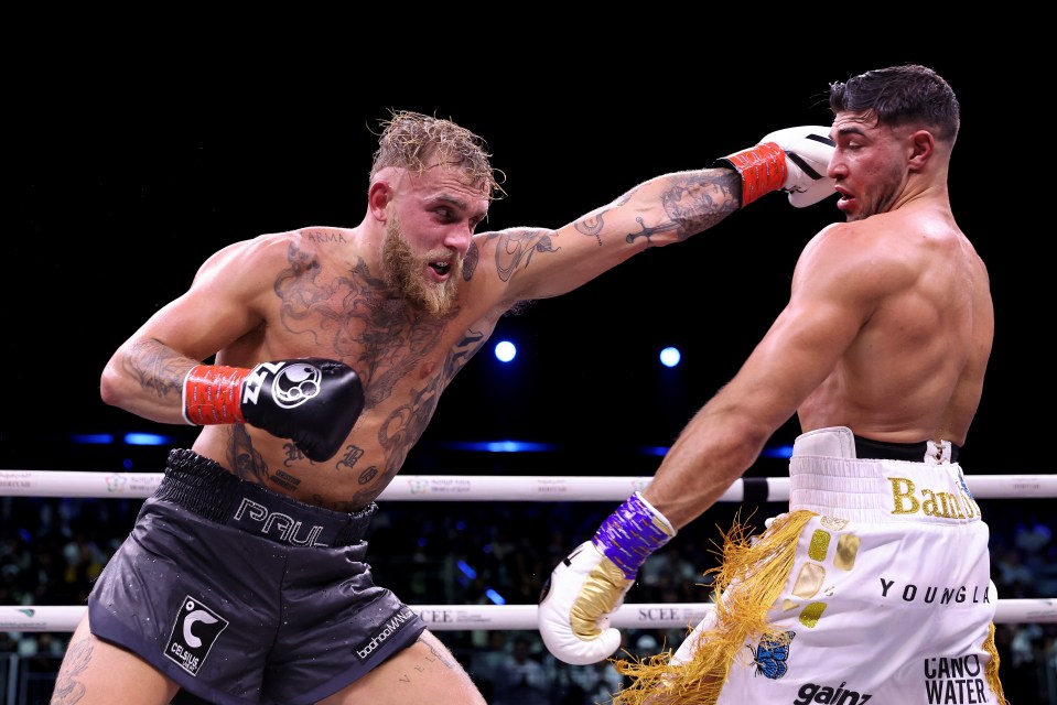 two boxers in a ring one of whom is wearing camo water shorts