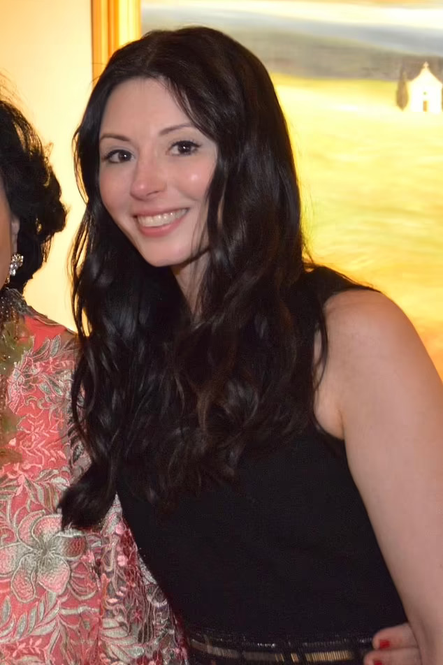 a woman in a black dress smiles for the camera