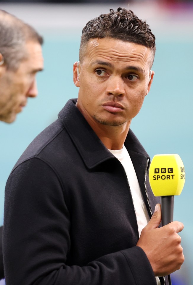 a man holding a yellow bbc sport microphone