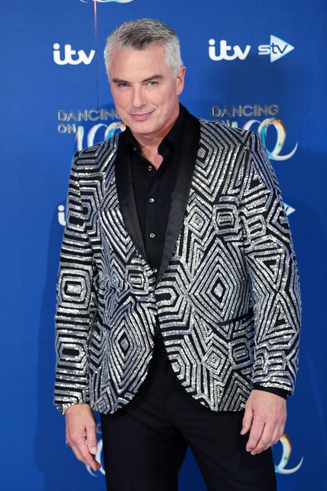 a man in a sequined suit stands in front of a blue background that says itv