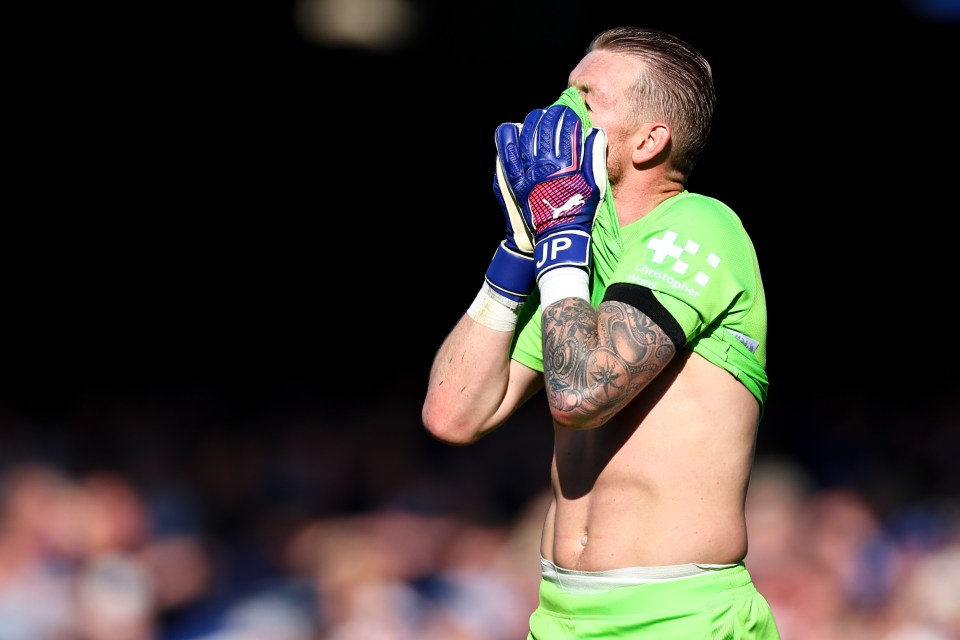 Jordan Pickford puts his shirt over his face after Everton's loss to Bournemouth