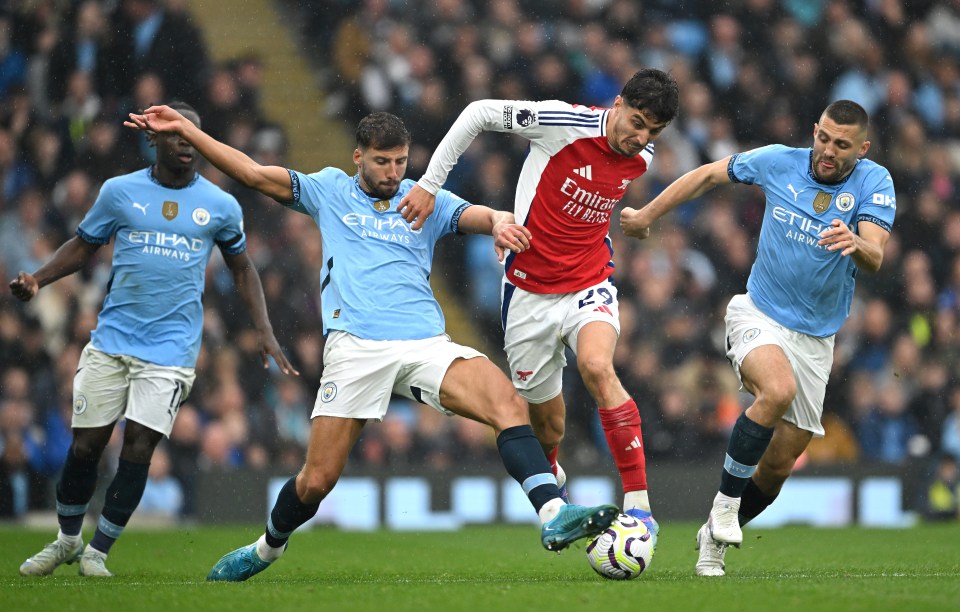 soccer players wearing jerseys that say etihad airways