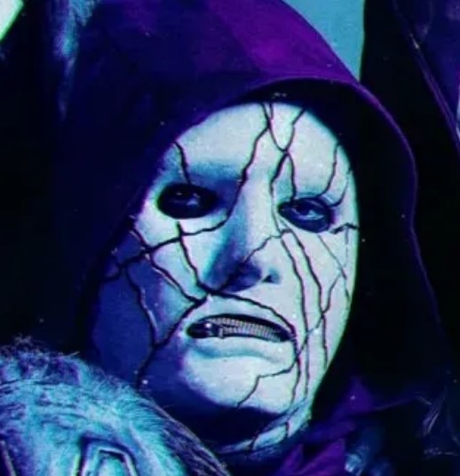 a close up of a person wearing a purple hooded mask .