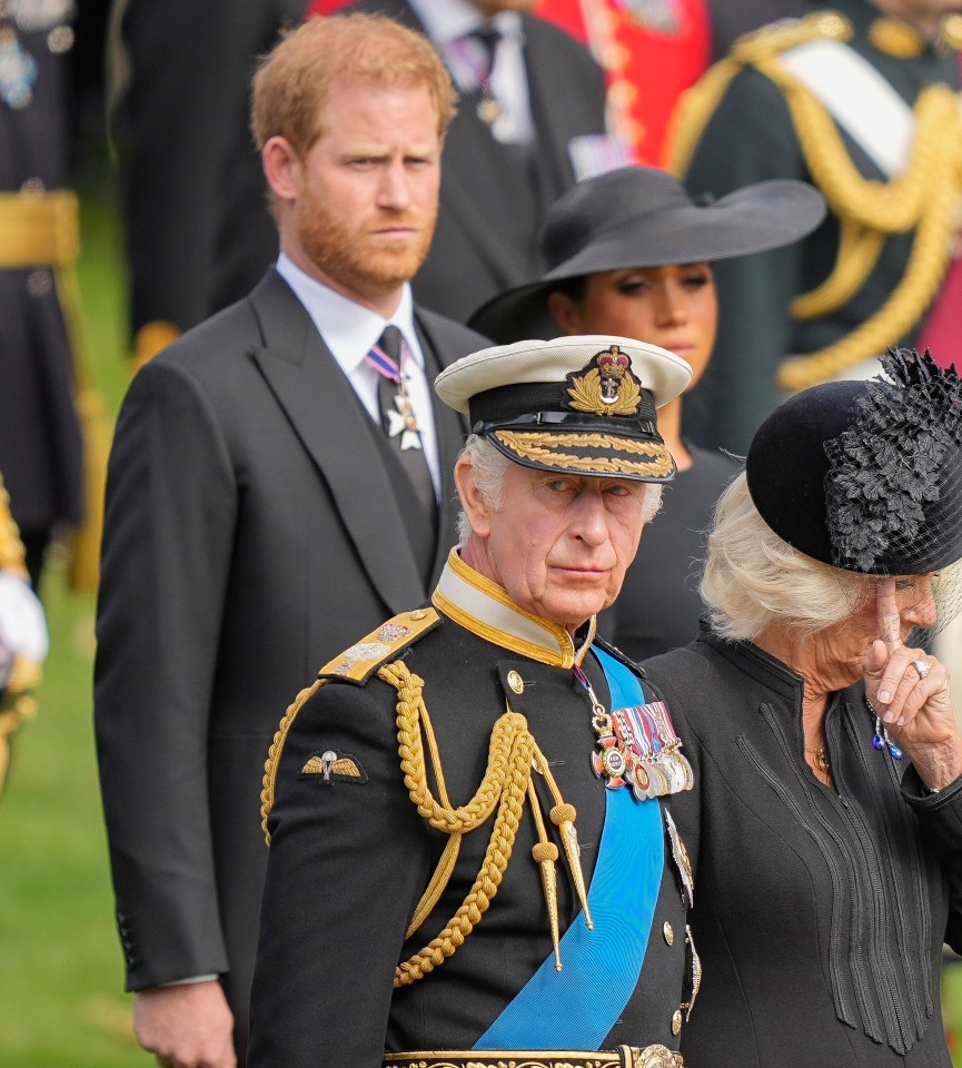 a man in a military uniform stands next to a woman in a black hat