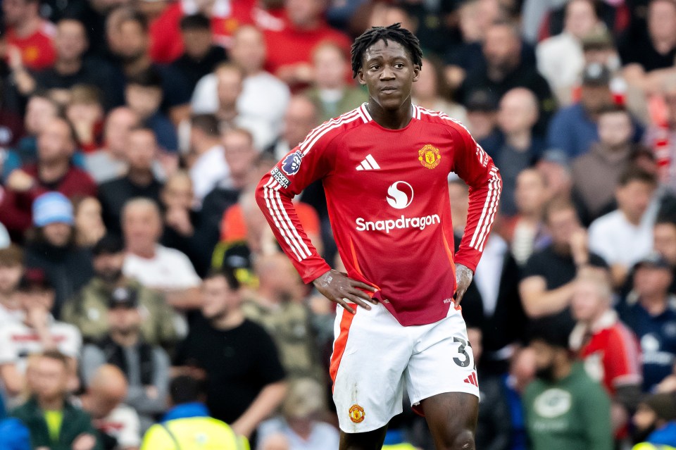 a soccer player wearing a red shirt with snapdragon on it