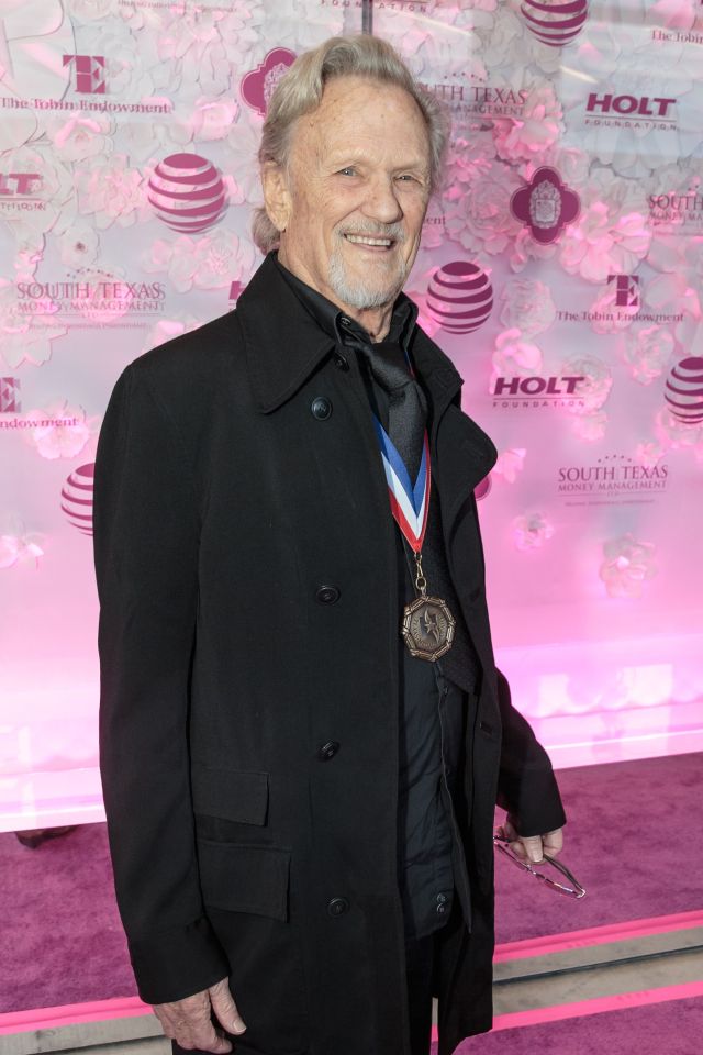 a man wearing a medal stands in front of a pink background that says south texas