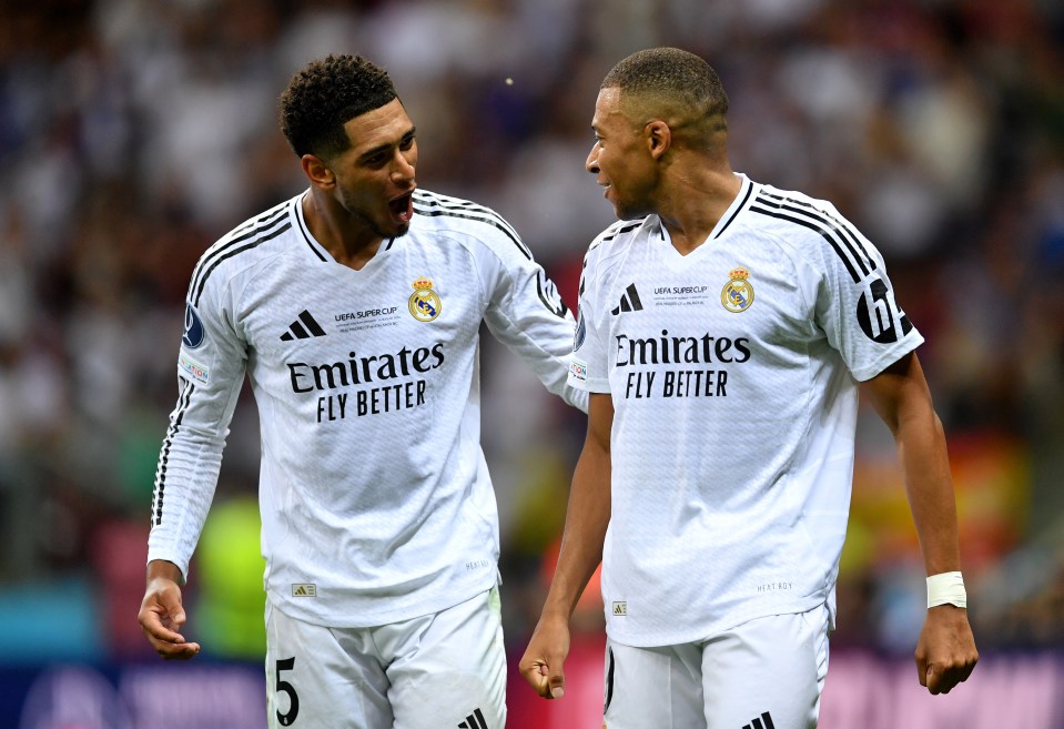 two soccer players wearing emirates fly better shirts