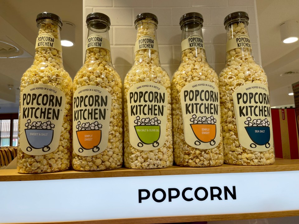 bottles of popcorn kitchen are lined up on a shelf