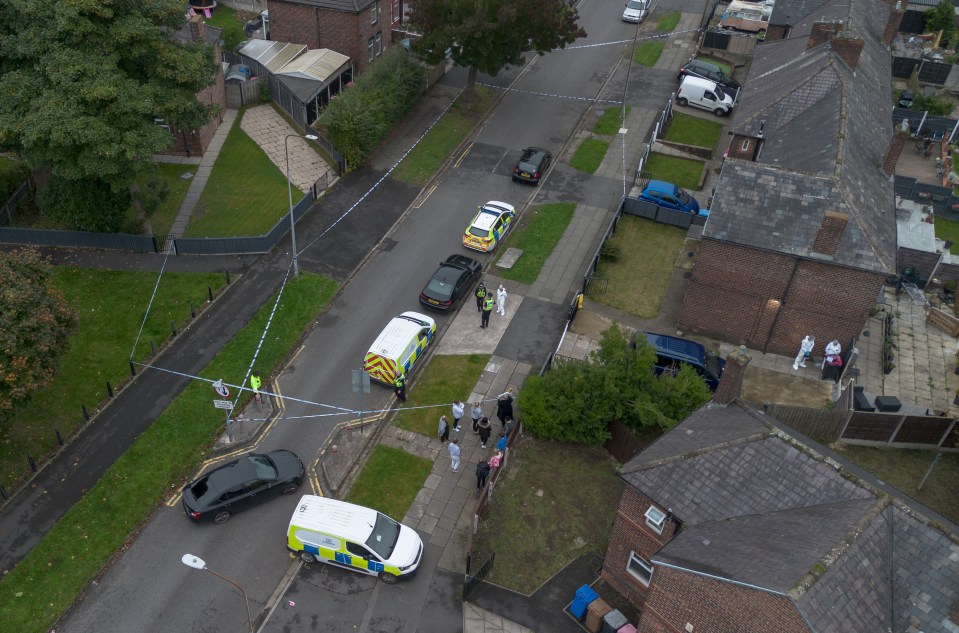 A large police presence with police forensic officers and a cordon on South Radford Street