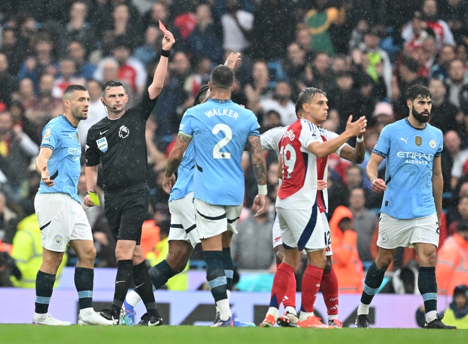 a referee shows a red card to walker during a soccer game