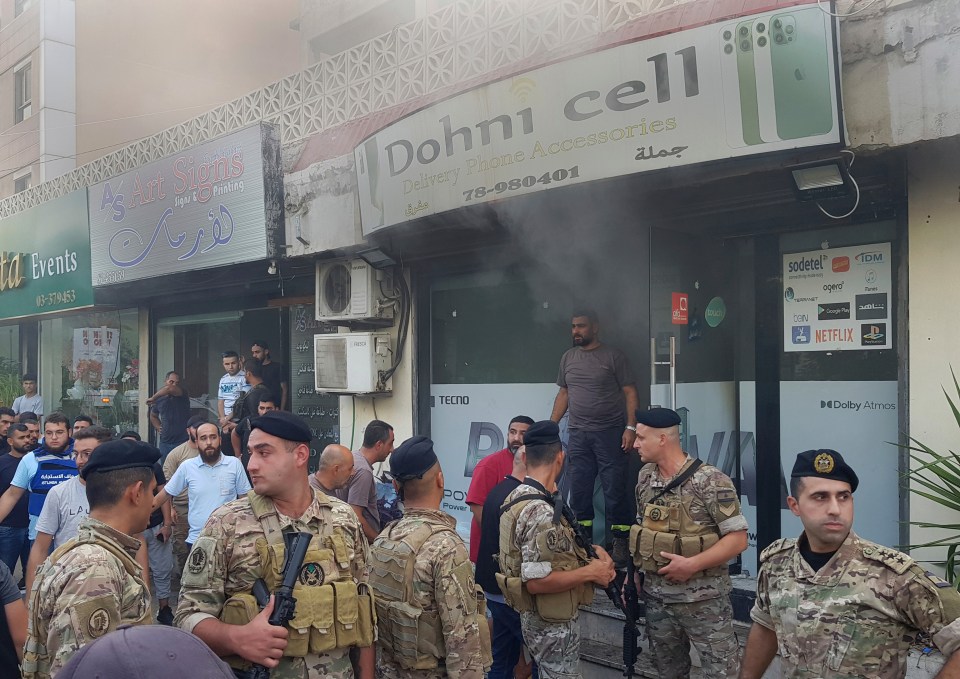 Lebanese soldiers outside a damaged mobile shop after a walkie-talkie exploded inside, in Sidon