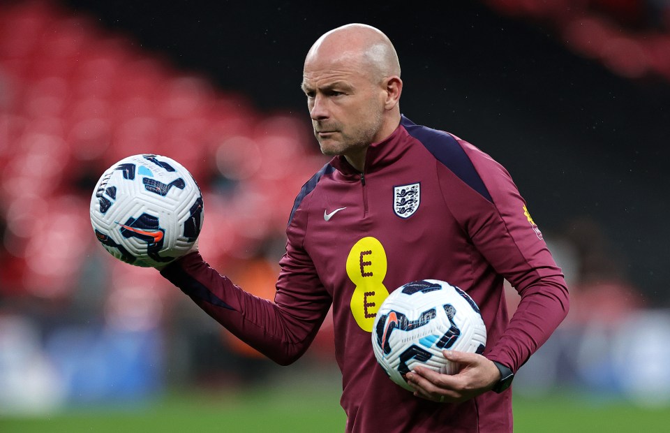 a man holding a soccer ball with the letter e on his shirt