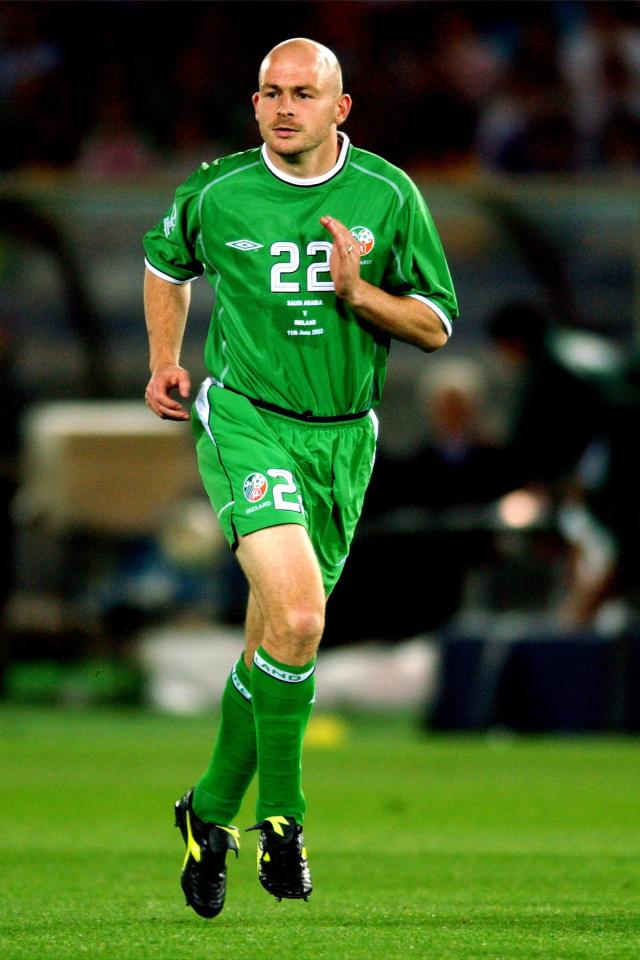 a man wearing a green jersey with the number 22 on it