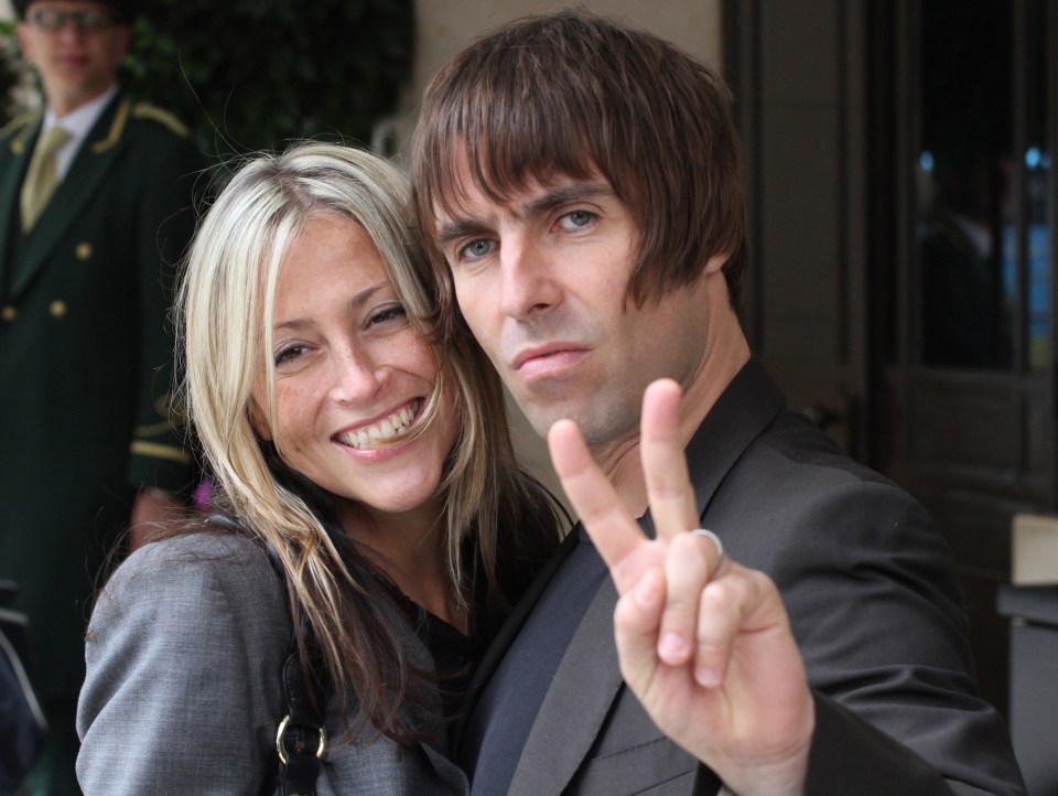 a man giving a peace sign next to a woman