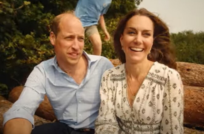 a man and a woman are sitting on a log and smiling .