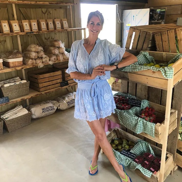 a woman stands in front of a display of selected potatoes