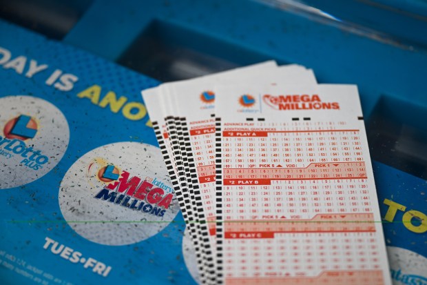 several mega millions tickets are stacked on top of each other