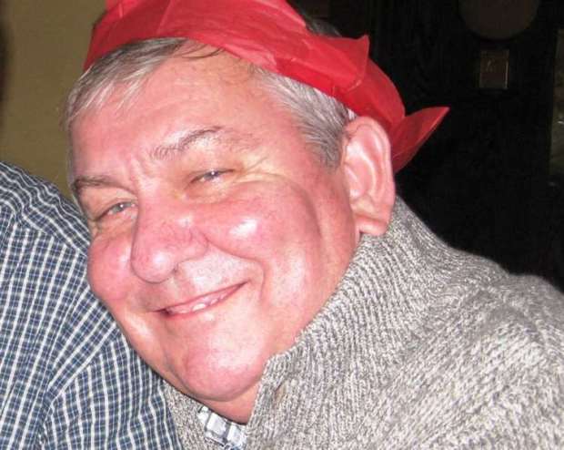 a man wearing a red hat and sweater smiles for the camera