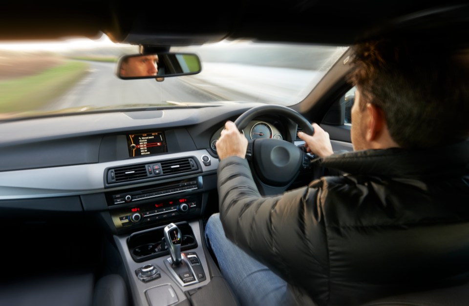 a man is driving a car with a screen that says ' a ' on it