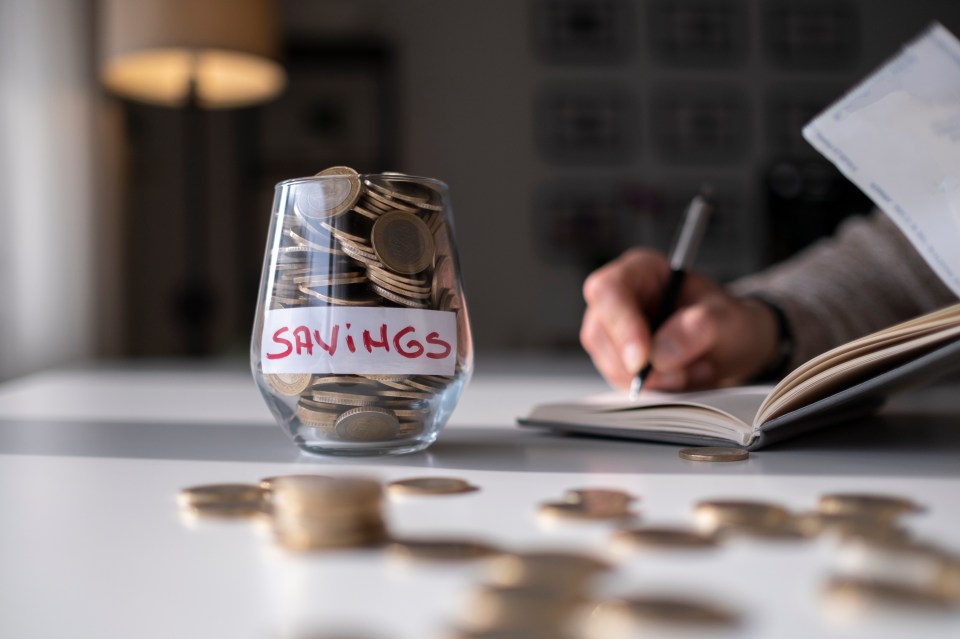 a glass filled with coins has a label that says savings