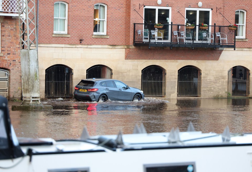 A man moves his car in York city centre as the River Ouse rises with intense overnight rainfall causing flooding