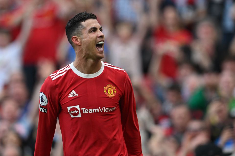 a soccer player wearing a red teamviewa jersey