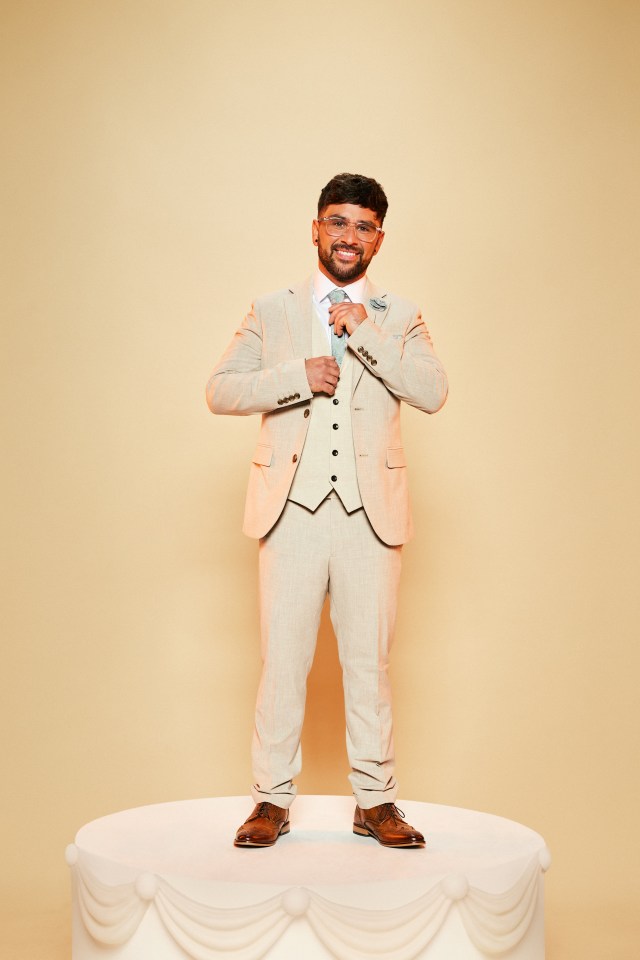 a man in a suit is standing on top of a cake