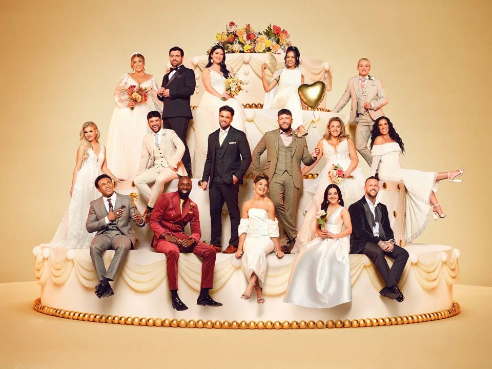 a group of people sitting on top of a wedding cake