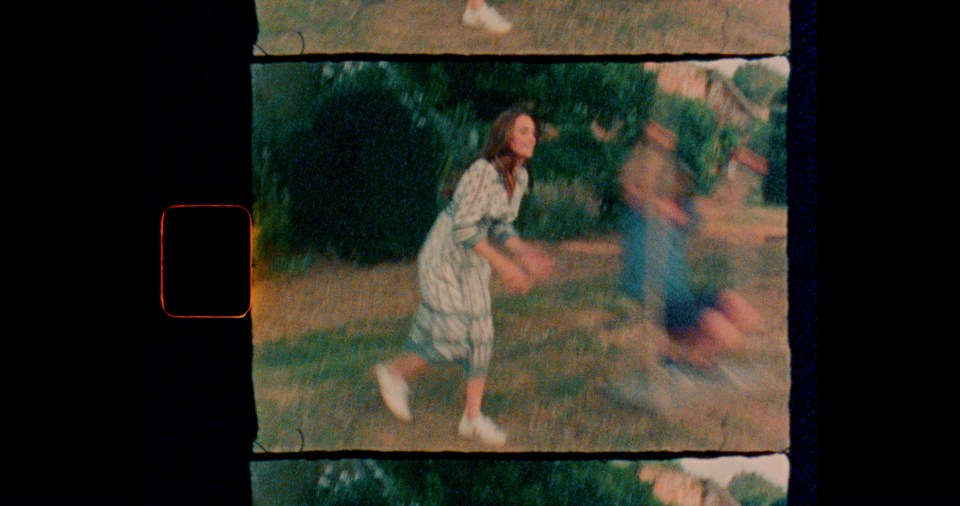 a woman in a striped dress is running in a field