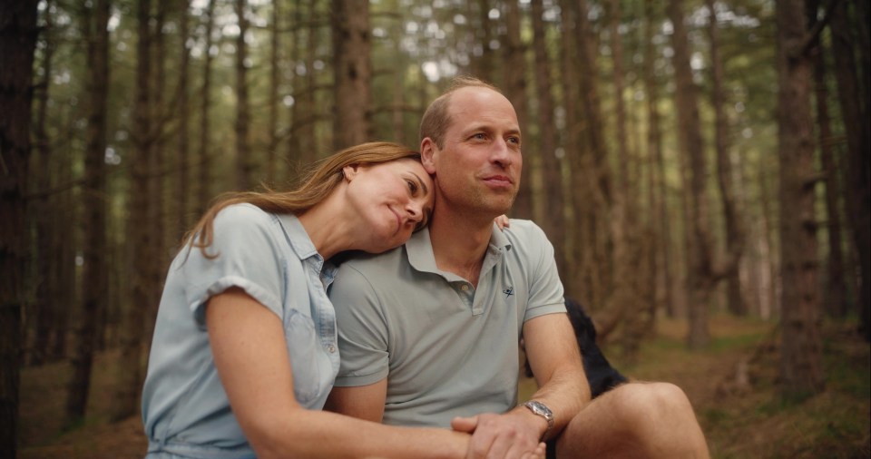 a man and a woman are sitting in the woods