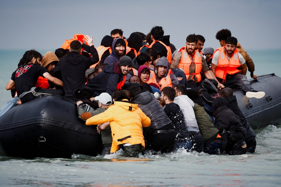 The moment that more people attempted to get onboard an already overcrowded dinghy was captured on a French beach this morning