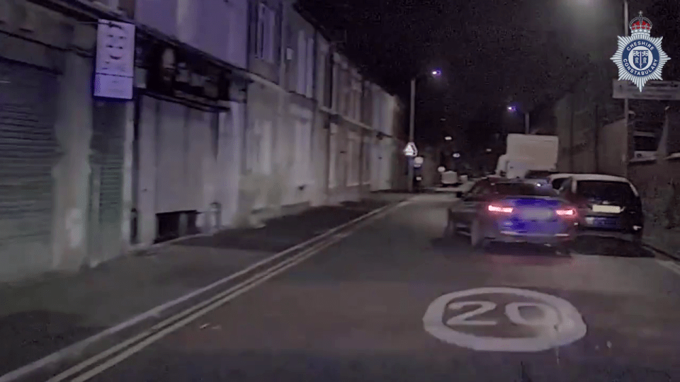 a car is driving down a street with a speed limit of 20