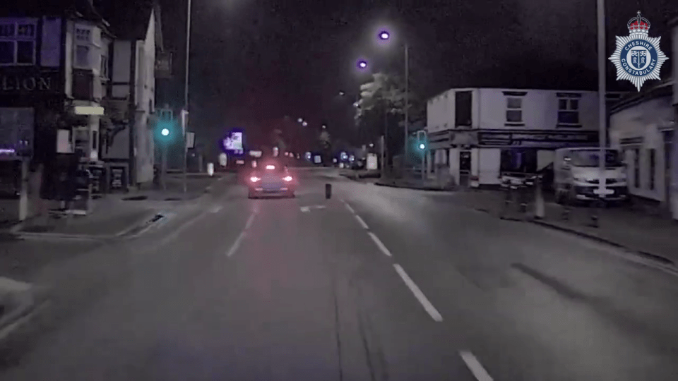 a car is driving down a street in front of a store called lion