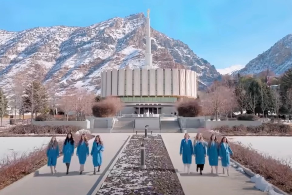 a group of women standing in front of a building with the word temple on it