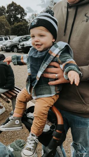 a man is holding a baby in a stroller .