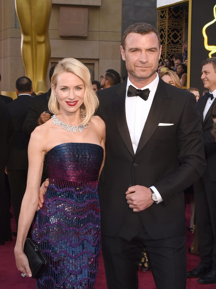 a man and woman are posing for a picture on a red carpet