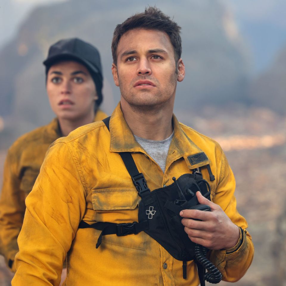 a man in a yellow shirt has a badge on his chest that says ' emergency '