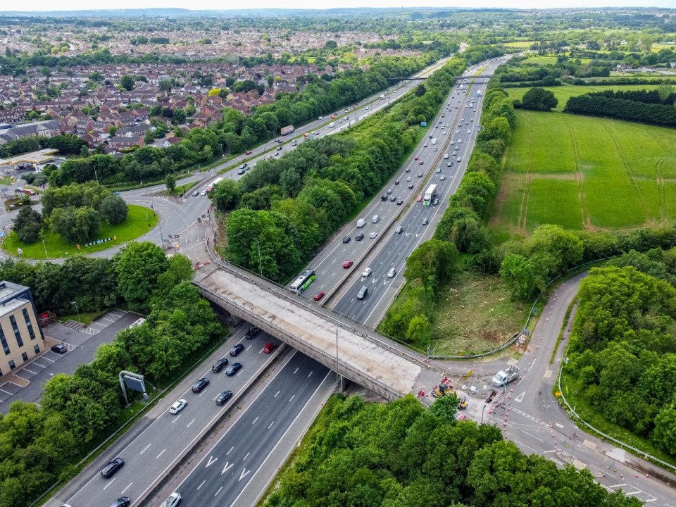 an aerial view of a highway going through a residential area