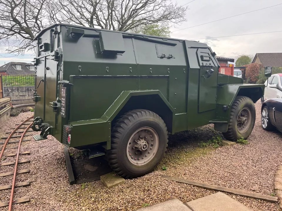 a green military vehicle with a license plate that says tc 895