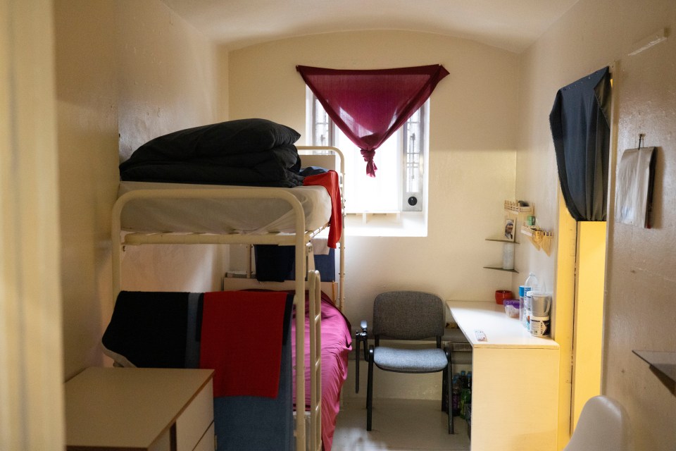 a small room with a bunk bed and a desk