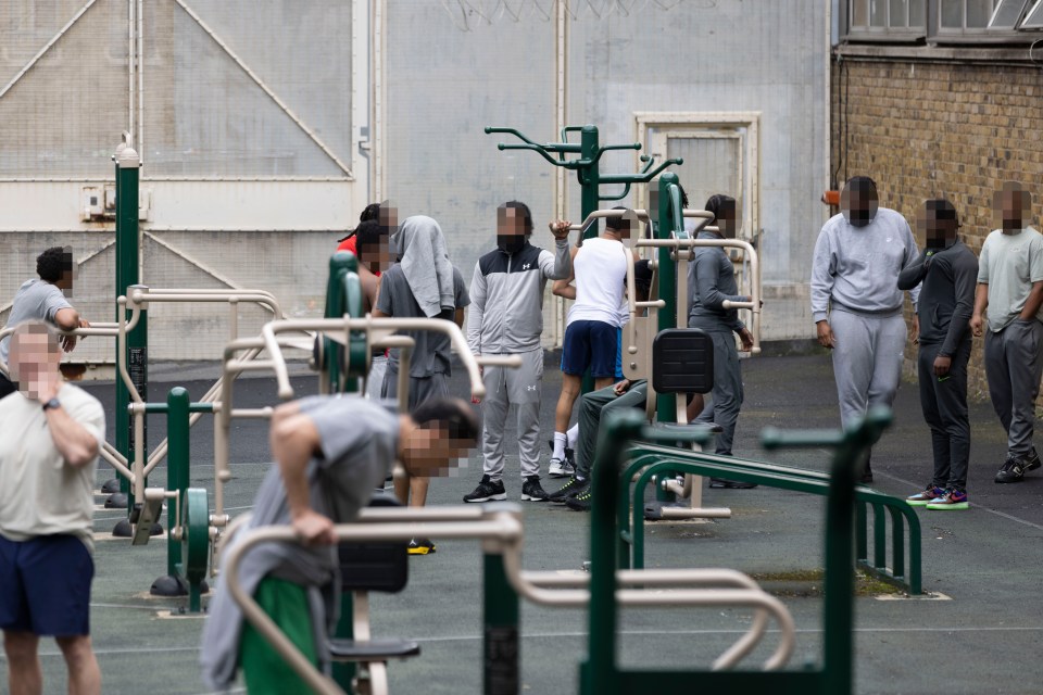 a group of men are doing exercises in a park with their faces blurred