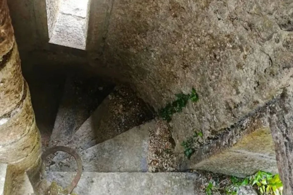 a set of stone stairs leading up to a cave