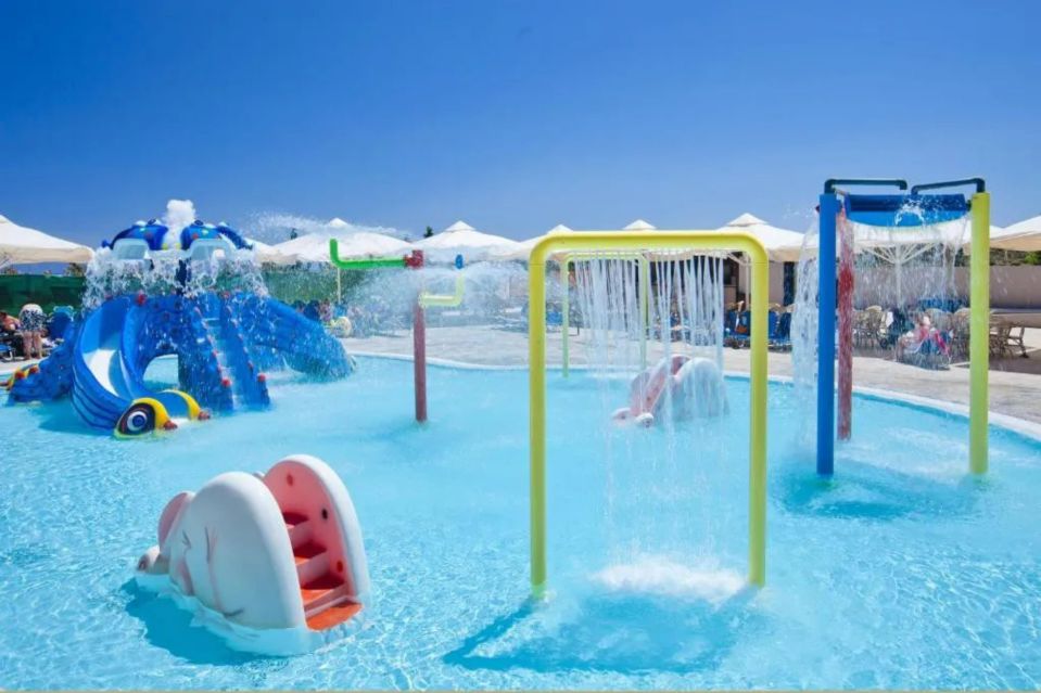 a water park with a slide and a waterfall