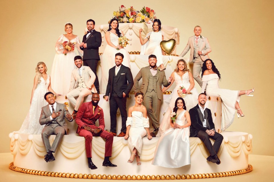 a group of people sitting on top of a wedding cake